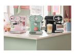 Three retro-style SilverCrest espresso machines in pink, mint green, and black on a kitchen counter.