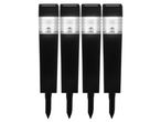 Four black solar-powered garden lights with clear ribbed tops and ground stakes.