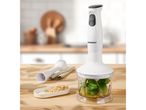 SilverCrest immersion blender with a chopper attachment containing basil and oil, next to a dish of pine nuts.