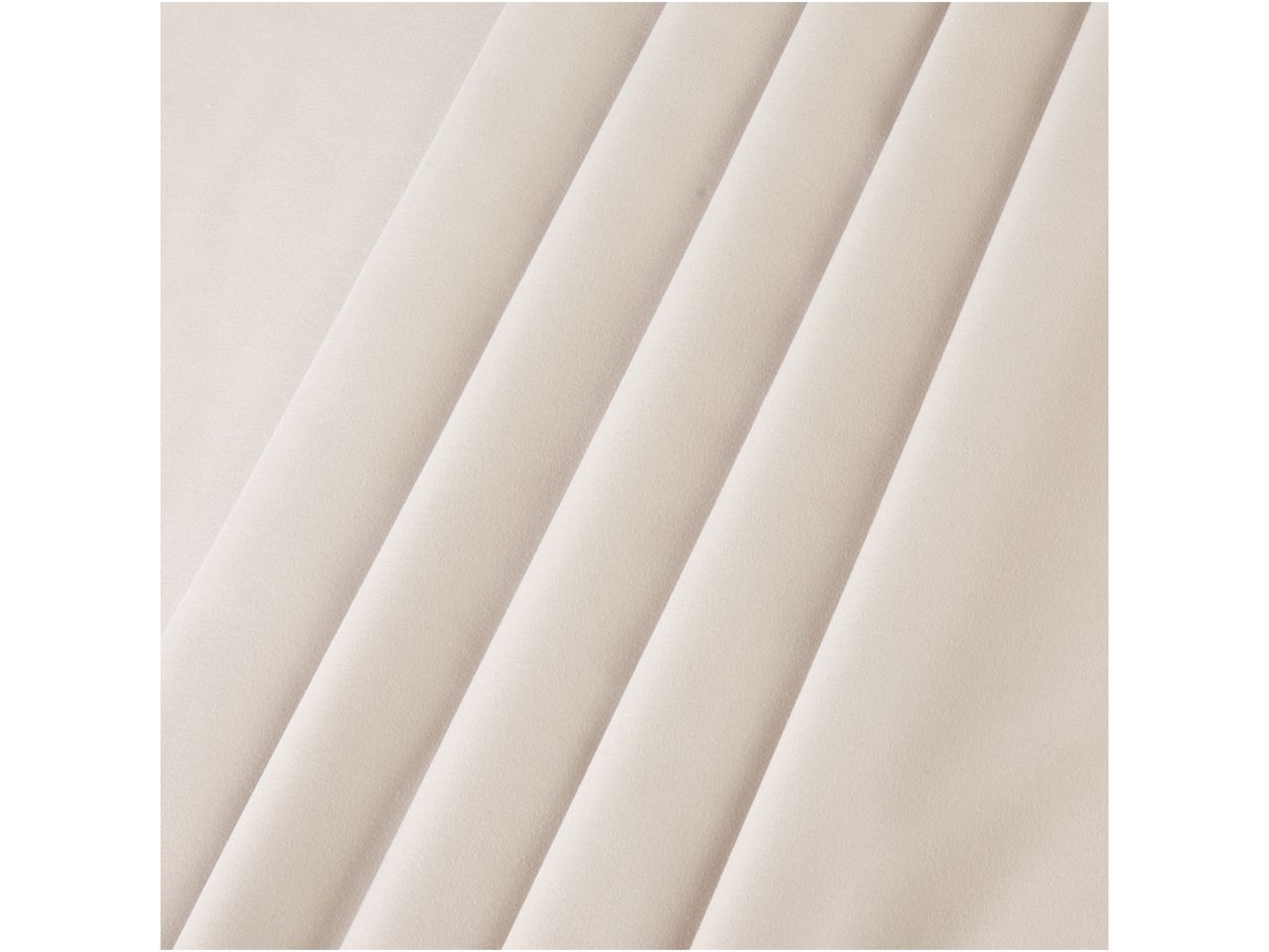 Close-up of a beige pleated fabric with diagonal folds