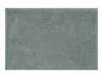 A sage green bath mat with a textured surface.