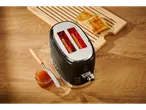 Silvercrest 980 W toaster with toast and jam on a wooden surface.