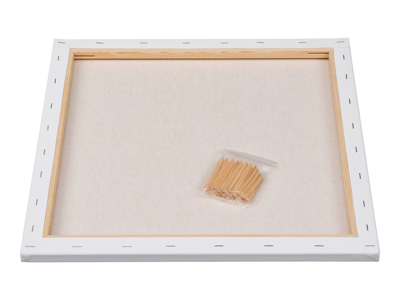 Back of a blank stretched canvas with wooden stretcher bars and a bag of wooden wedges.