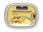 Kartoffelsalat med karry i en bakke, med et billede af salaten i en skål.