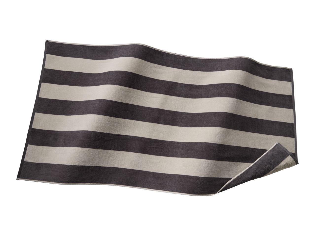 Striped bath mat in dark grey and light grey, with a slight curl on one corner.