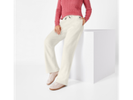 Woman in a pink cable-knit sweater and cream wide-leg sweatpants with pink sneakers.