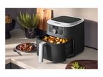 A black air fryer with a digital display, filled with roasted potatoes on a kitchen counter.