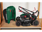 Parkside® Petrol Lawnmower with grass collector on a wooden shelf.