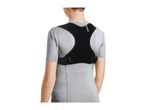 Rear view of a person wearing a black posture corrector over a grey t-shirt.