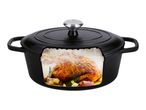 Black cast iron Dutch oven with a roasted chicken, garlic, and herbs inside.