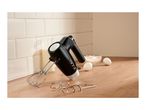 Black hand mixer with beaters and dough hooks on a kitchen counter