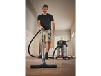 Man cleaning floor with a Parkside industrial vacuum cleaner.