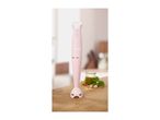 Pink SilverCrest hand blender on a wooden surface with pesto ingredients.