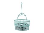 Light blue laundry basket with clothes pegs.