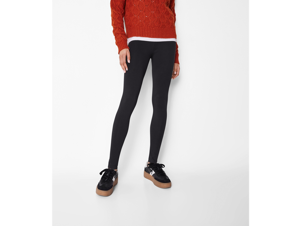 A woman models Esmara Ladies' Leggings with a rust-colored sweater and black platform sneakers.