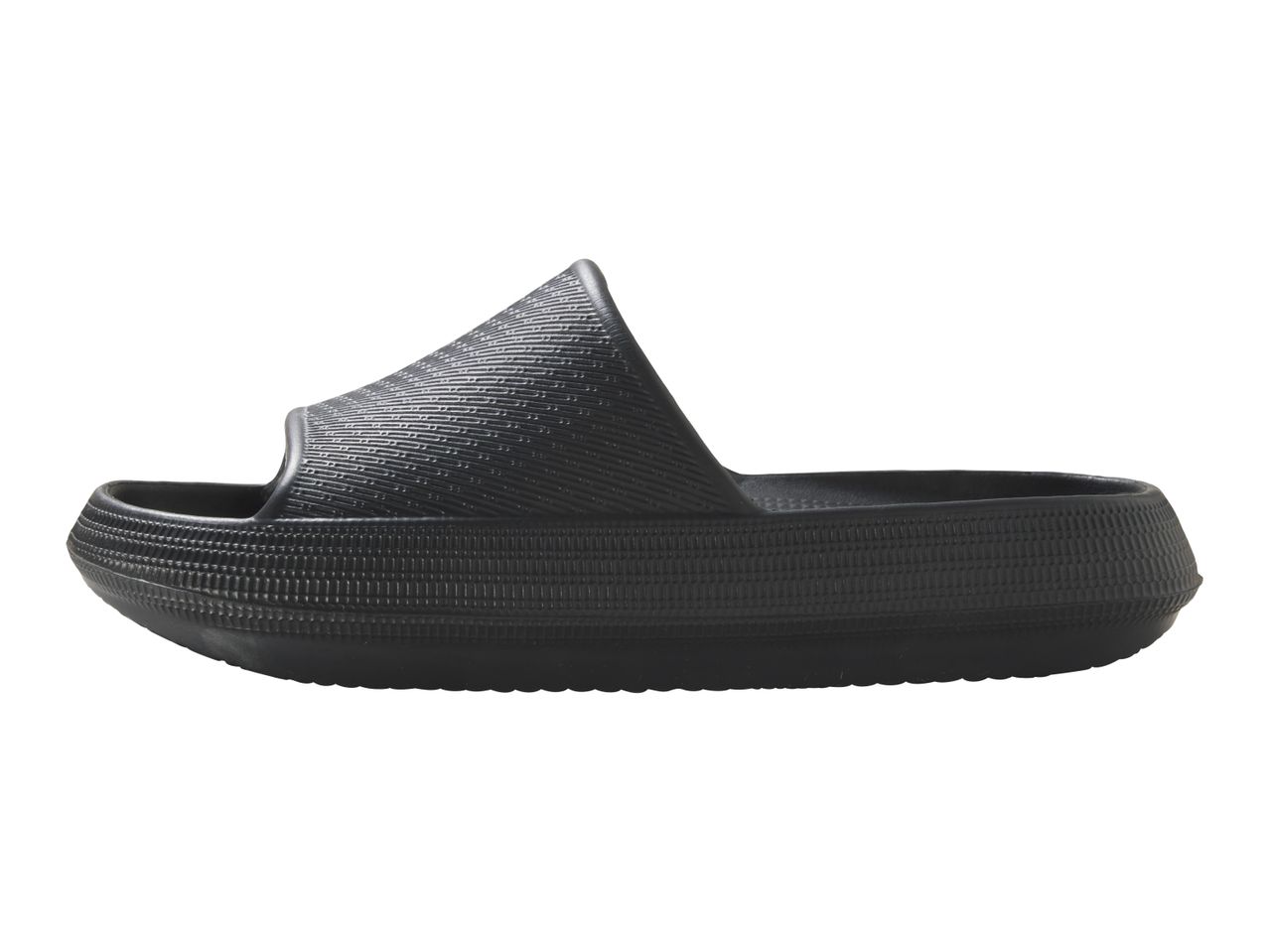 A single black slide sandal with a textured surface, viewed from the side.