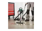 Parkside wet and dry vacuum cleaner cleaning a spill next to a tool cabinet.