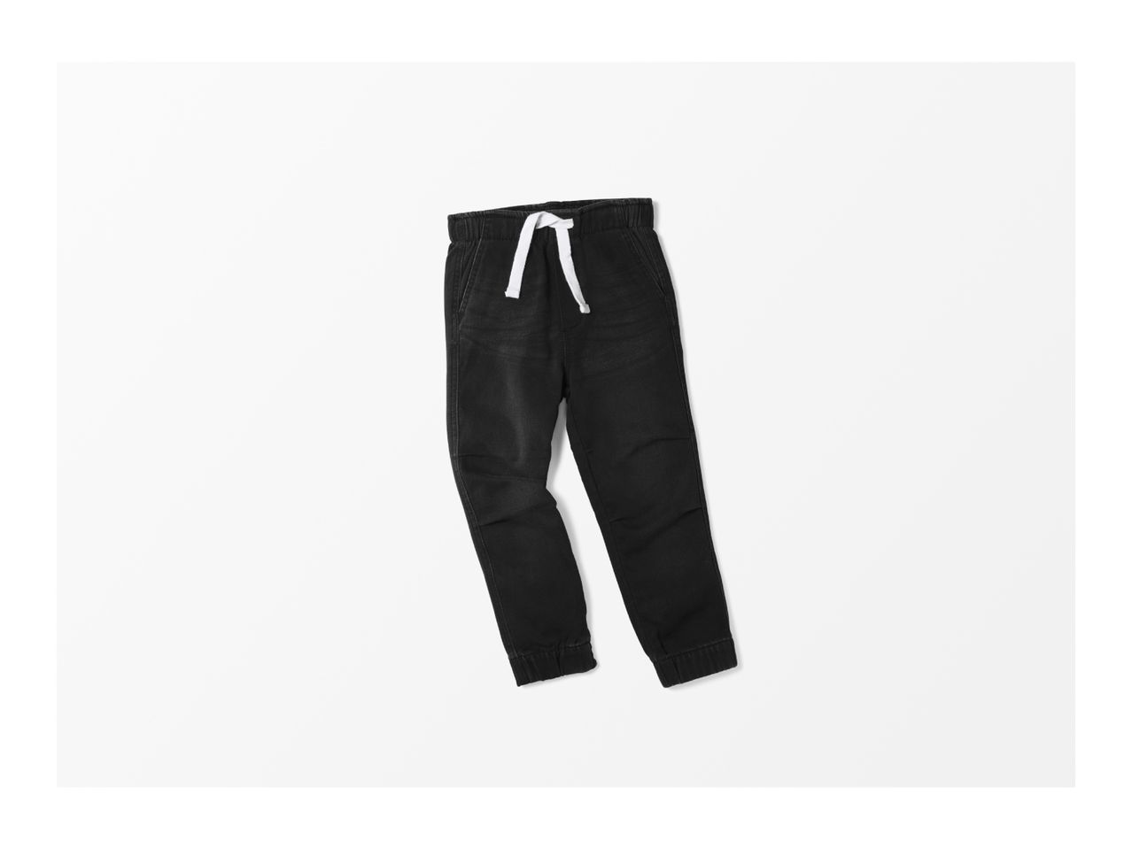 Black denim joggers with a white drawstring on a white background.
