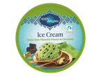 Pistachio ice cream with chocolate chips, pistachios, and chocolate chunks on a patterned background.