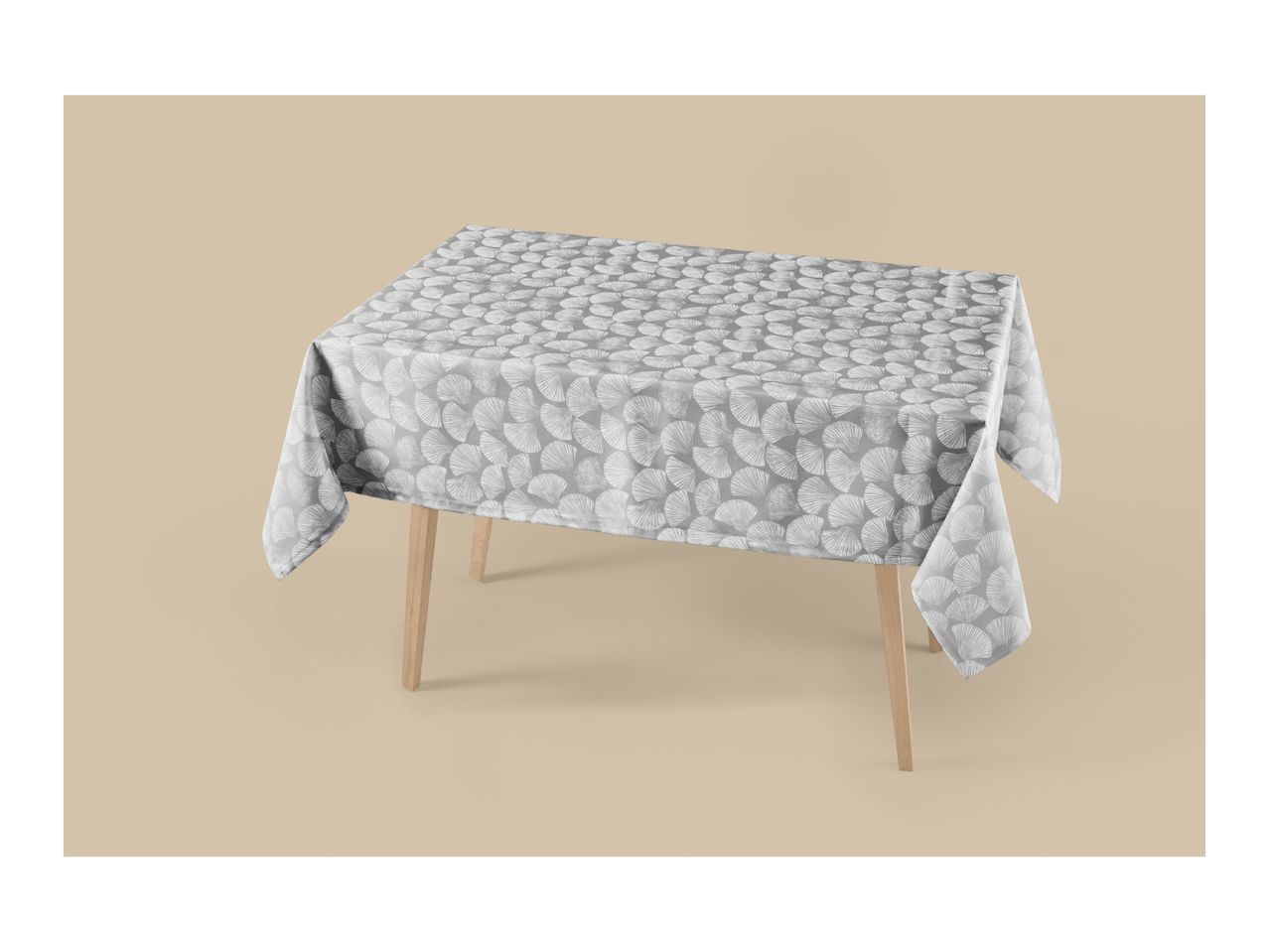 Grey tablecloth with a white seashell pattern on a light brown background.