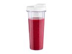 Blender cup filled with red smoothie