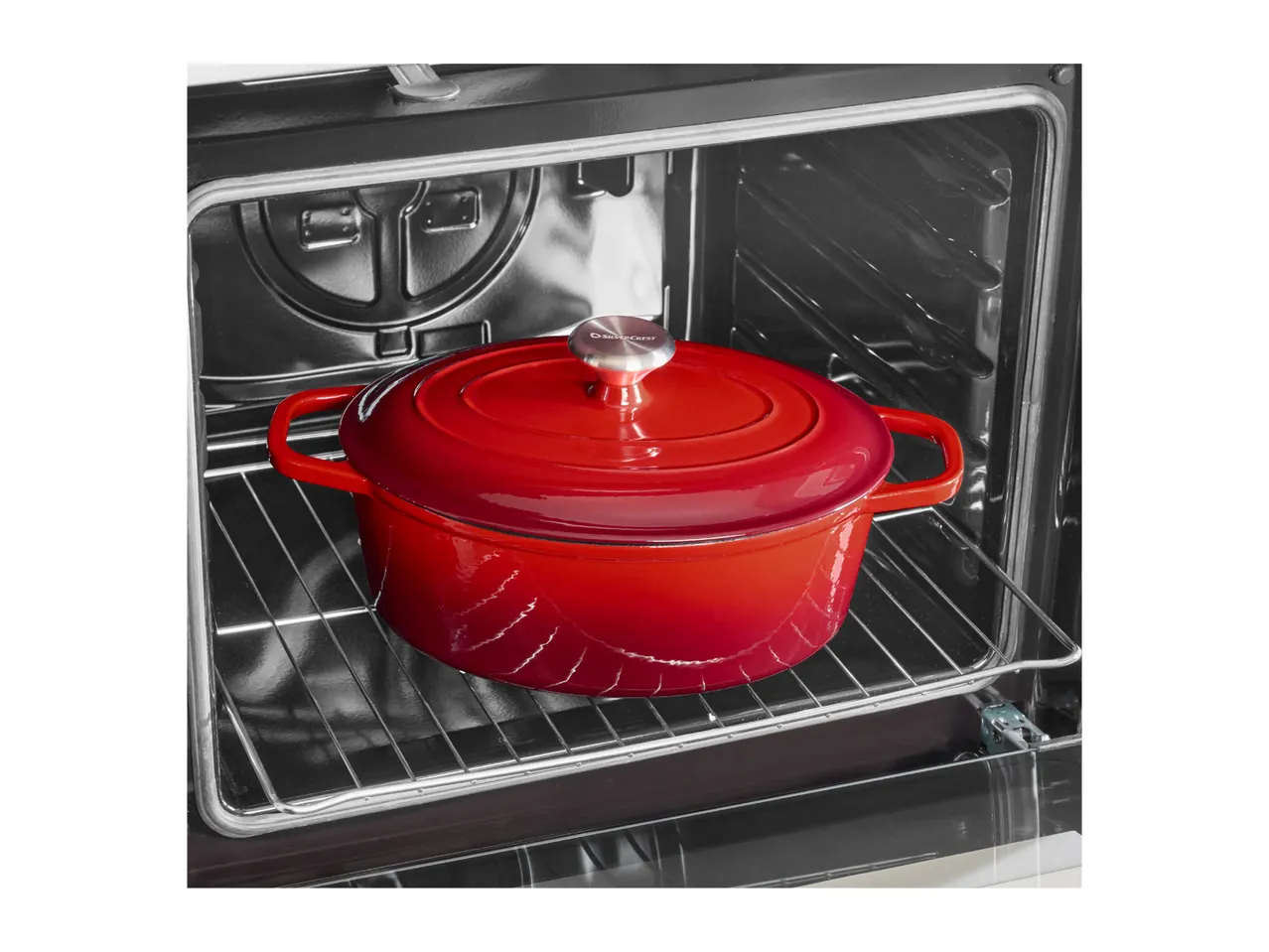 Red cast iron pot inside an oven