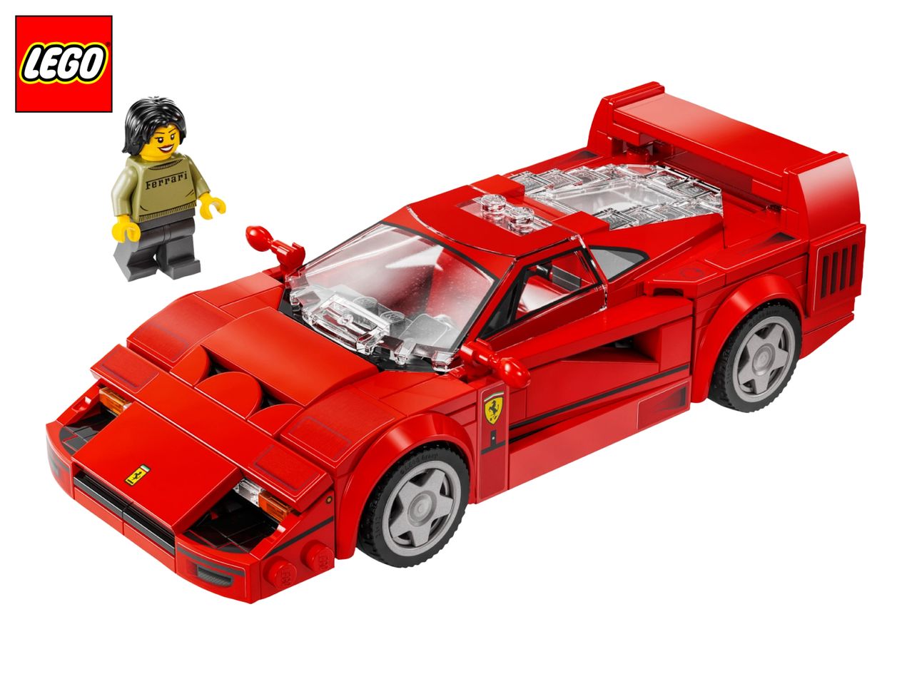 Red toy sports car with a minifigure wearing a sweater with text, on a white background.
