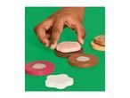 A child's hand placing a pink wooden cookie with sprinkles on a brown wooden cookie.