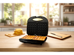 Fresh waffles and a waffle maker in the kitchen.