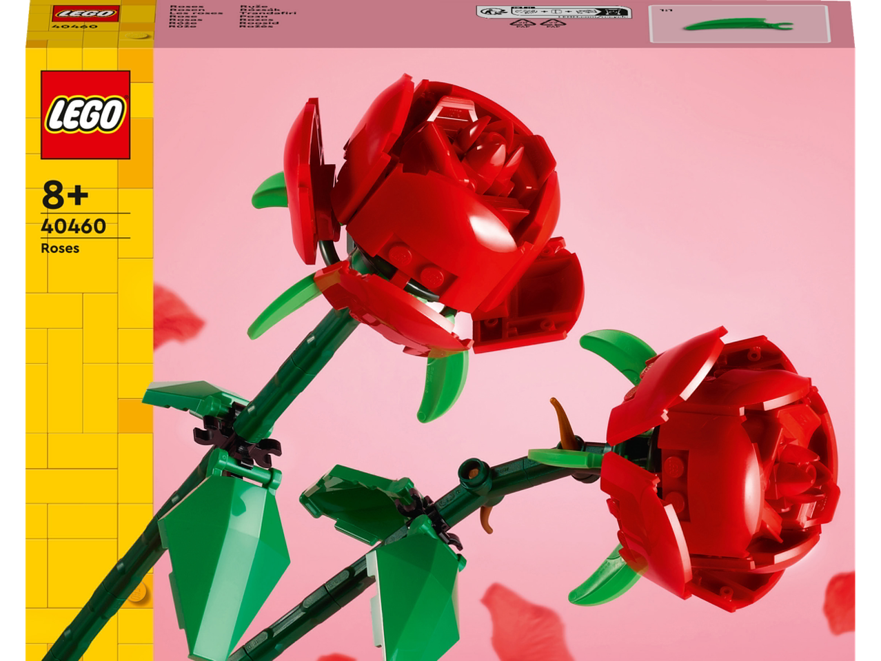 Két piros rózsa figura zöld szárral és levelekkel rózsaszín háttéren.