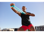 Man exercising with Crivit resistance band.