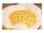 A Cath Kidston bee-themed pet bed with a yellow inner cushion and cream outer.