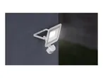 Outdoor LED floodlight with motion sensor mounted on a dark wall
