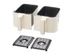 Two cream-colored air fryer baskets with black grates on a white background.