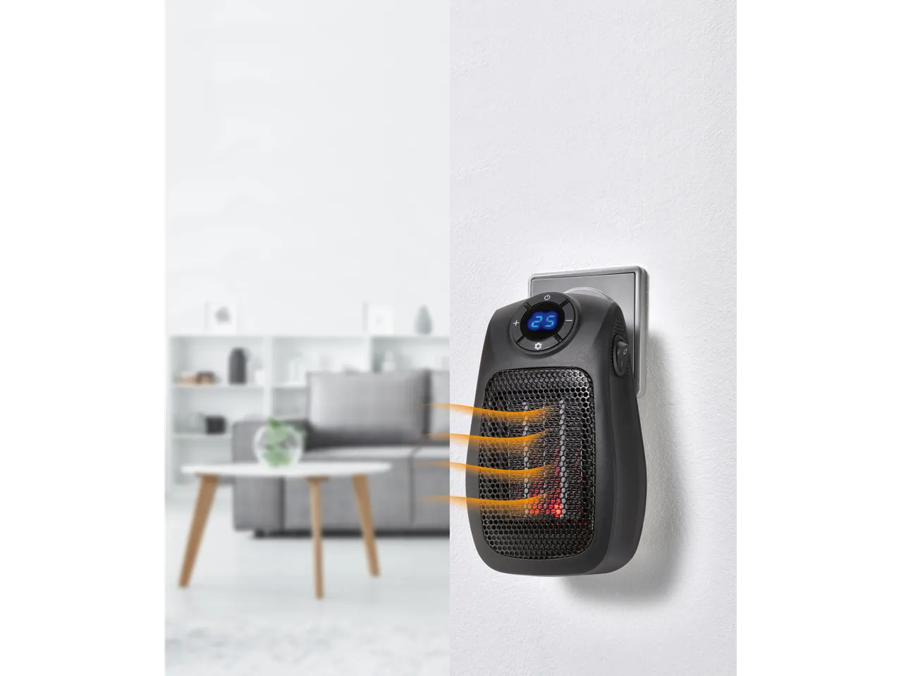 TRONIC® 600W Ceramic Plug Heater plugged into a wall socket, emitting heat, with a blurred living room in the background.