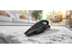 SilverCrest cordless vacuum cleaner on a white rug in a living room.