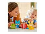 A woman and a child playing with colorful building blocks shaped like animals.