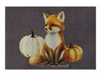 A cute fox sitting between a white and an orange pumpkin on a dark grey background.
