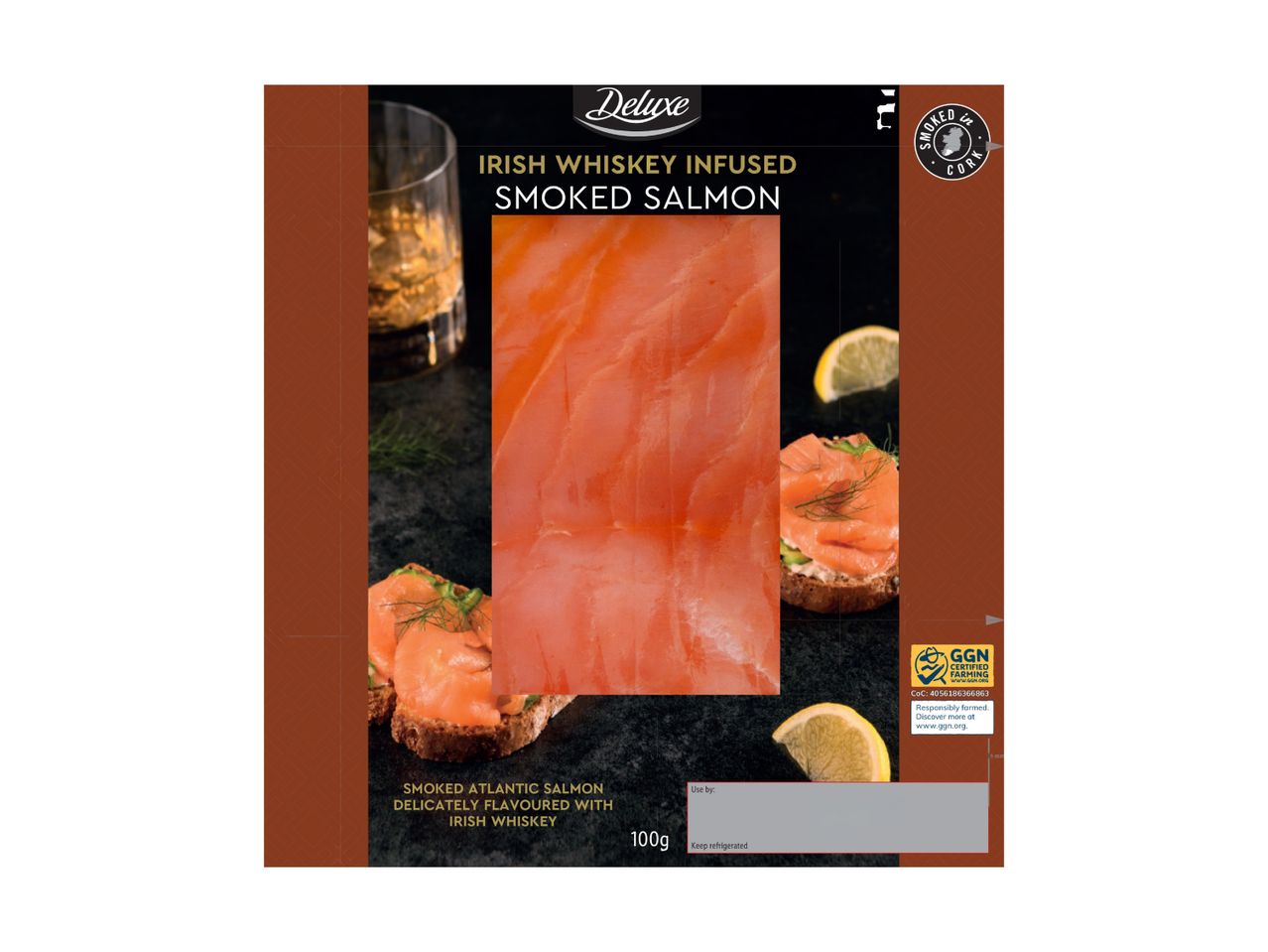 Irish whiskey-infused smoked salmon with a glass of whiskey and lemon slices.