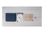 A drawing set with pencils, a sketchbook featuring a deer, a sharpener, erasers, and blending stumps.