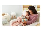 Mother and baby holding a plush otter toy with a glowing belly, sitting on a chair.