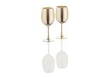 Two gold metallic wine glasses on a reflective surface.