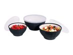 Three black bowls with white interiors, two filled with food, and three clear lids.