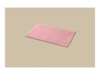 A pink bath mat with a textured surface, viewed from an angle on a light beige background.