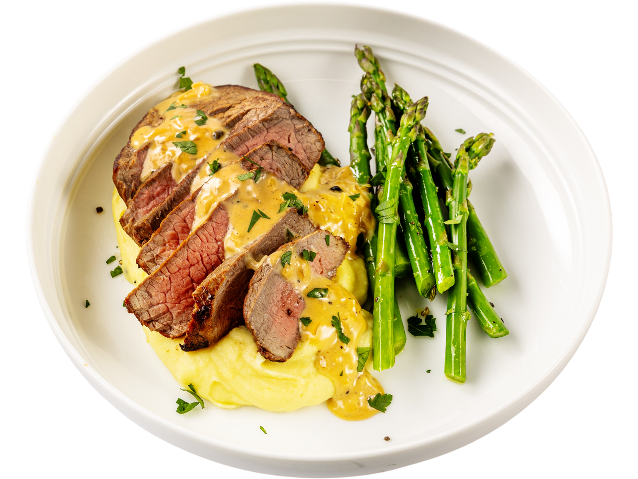 Sliced beef medallions with sauce, mashed potatoes, and asparagus on a white plate.