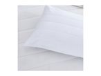 White quilted pillow on a white quilted mattress pad.