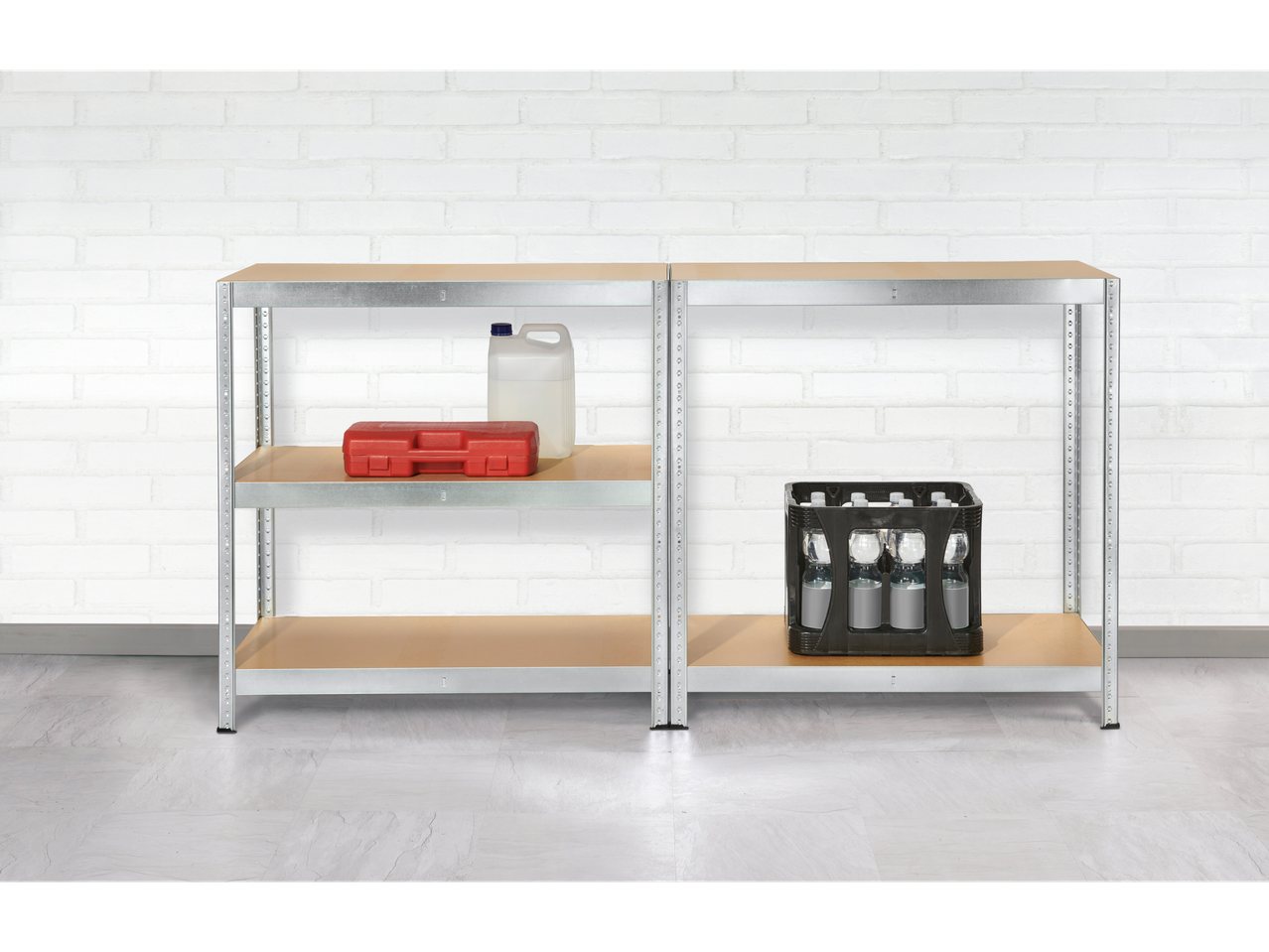 Two metal shelving units with beige shelves hold a toolbox, a plastic canister, and a crate of bottled water against a white brick wall.