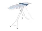 Ironing board with a blue and white seashell pattern, white legs, and a white iron rest.