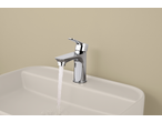 Livarno Mixer Tap with running water in a white sink against a beige wall.