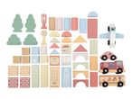 Pastel-colored wooden building blocks, including houses, vehicles, trees, and traffic signs.